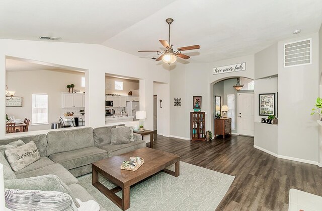 5783 N State St, Fresno, CA 93722 - living room with ceiling fan, lofted ceiling, dark wood-style floors, and arched walkways