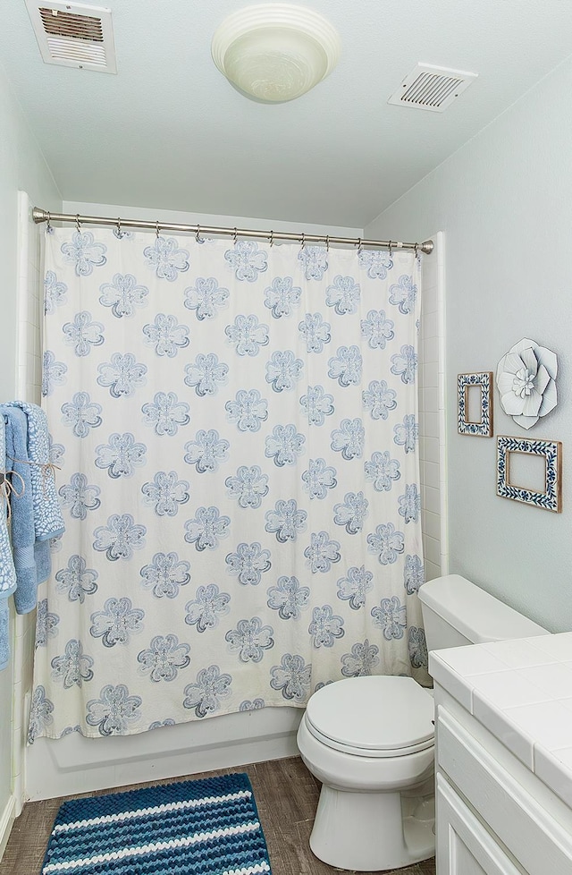 5783 N State St, Fresno, CA 93722 - full bathroom featuring wood finished floors, vanity, and shower / bath combo