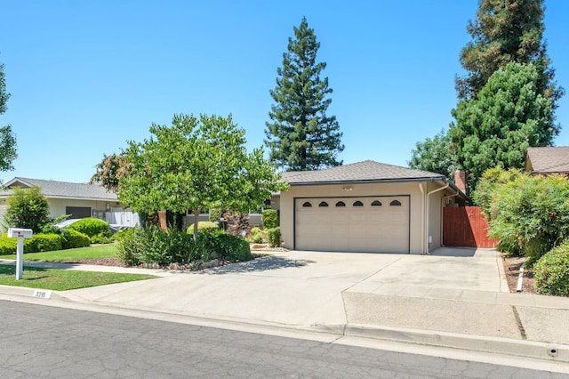 3218 E Ellery Ave, Fresno, CA 93710 - view of front of house featuring an attached garage, driveway, and stucco siding