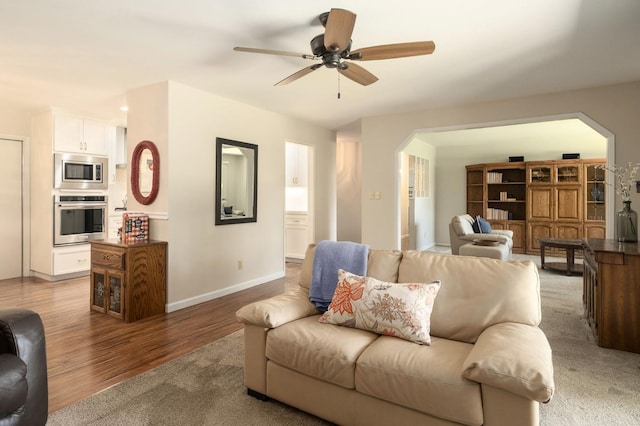 3218 E Ellery Ave, Fresno, CA 93710 - living area featuring wood finished floors, ceiling fan, and arched walkways