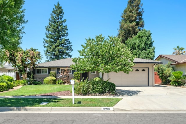 3218 E Ellery Ave, Fresno, CA 93710 - ranch-style house with a garage, driveway, a front lawn, and stucco siding