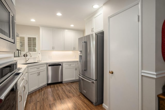 3218 E Ellery Ave, Fresno, CA 93710 - kitchen with stainless steel appliances, white cabinetry, dark wood-type flooring, backsplash, and recessed lighting