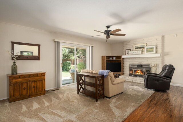 3218 E Ellery Ave, Fresno, CA 93710 - living area featuring ceiling fan, a brick fireplace, and wood finished floors