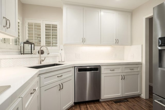 3218 E Ellery Ave, Fresno, CA 93710 - kitchen with appliances with stainless steel finishes, decorative backsplash, white cabinets, and light countertops