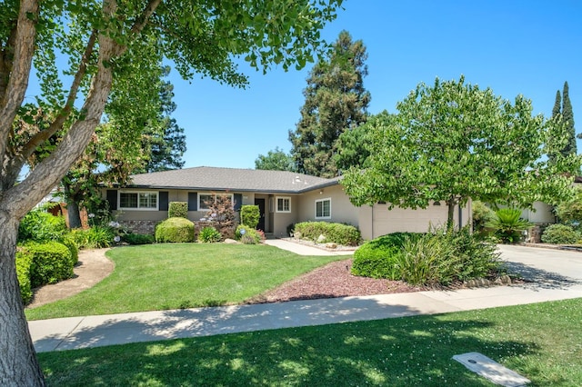 3218 E Ellery Ave, Fresno, CA 93710 - ranch-style house featuring a garage, a front yard, concrete driveway, and stucco siding