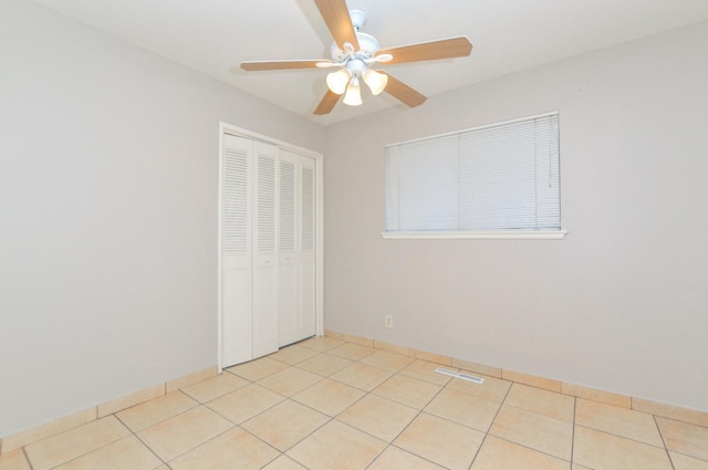 4879 E San Gabriel Ave, Fresno, CA 93726 - unfurnished bedroom with a closet, light tile patterned floors, and ceiling fan