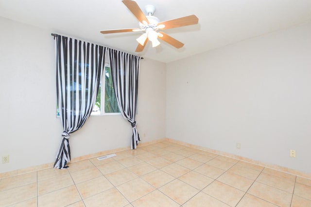 4879 E San Gabriel Ave, Fresno, CA 93726 - empty room with a ceiling fan and light tile patterned flooring