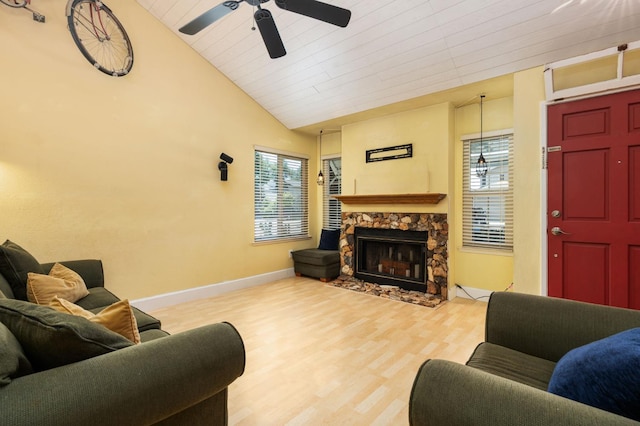 9938 N Canyon Creek Ln, Fresno, CA 93730 - living area with lofted ceiling, healthy amount of natural light, a ceiling fan, a stone fireplace, and wood finished floors