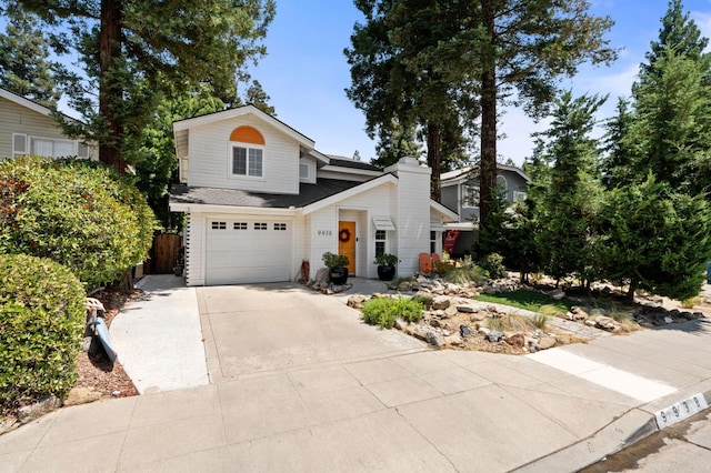 9938 N Canyon Creek Ln, Fresno, CA 93730 - view of front of house with concrete driveway, an attached garage, and roof with shingles