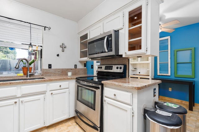 9938 N Canyon Creek Ln, Fresno, CA 93730 - kitchen with appliances with stainless steel finishes, white cabinetry, glass insert cabinets, and a ceiling fan
