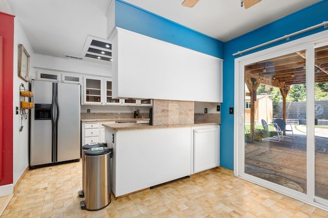 9938 N Canyon Creek Ln, Fresno, CA 93730 - kitchen with stainless steel refrigerator with ice dispenser, white cabinetry, light countertops, and glass insert cabinets