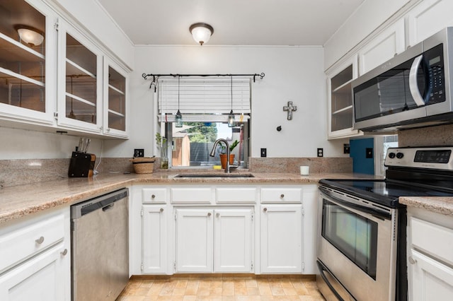 9938 N Canyon Creek Ln, Fresno, CA 93730 - kitchen featuring stainless steel appliances, white cabinetry, glass insert cabinets, and light stone counters
