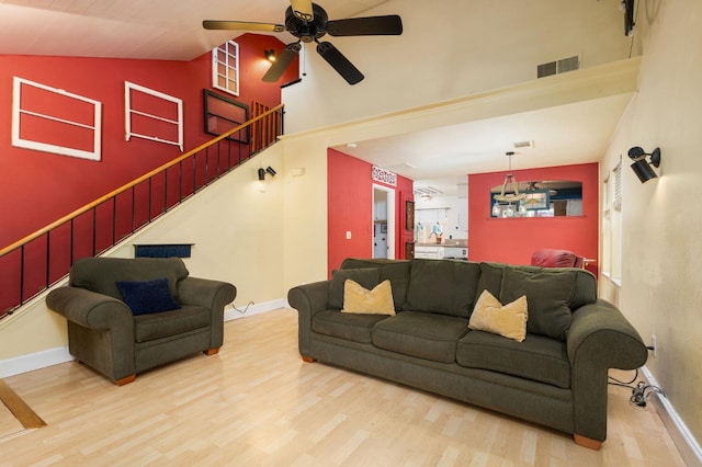 9938 N Canyon Creek Ln, Fresno, CA 93730 - living room featuring wood finished floors, ceiling fan, stairway, and high vaulted ceiling