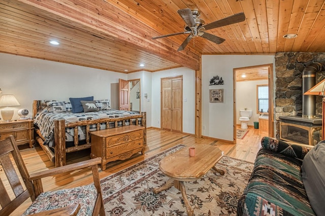 41798 Saddleback Rd, Shaver Lake, CA 93664 - bedroom with wooden ceiling, a wood stove, light wood finished floors, ensuite bathroom, and recessed lighting
