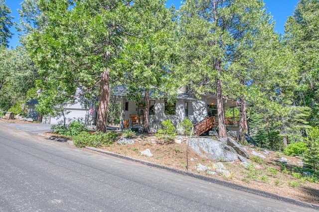 41798 Saddleback Rd, Shaver Lake, CA 93664 - view of property hidden behind natural elements featuring a garage, stairway, and covered porch