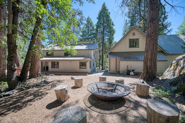 41798 Saddleback Rd, Shaver Lake, CA 93664 - back of property featuring an outdoor fire pit and a metal roof