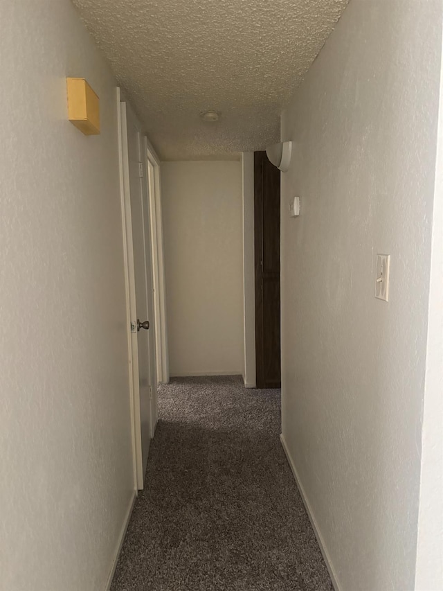 4303 N Emerson Ave, Fresno, CA 93705 - corridor with carpet floors, a textured ceiling, and a textured wall