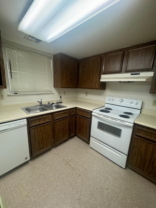 4303 N Emerson Ave, Fresno, CA 93705 - kitchen with white appliances, under cabinet range hood, dark brown cabinetry, and light countertops