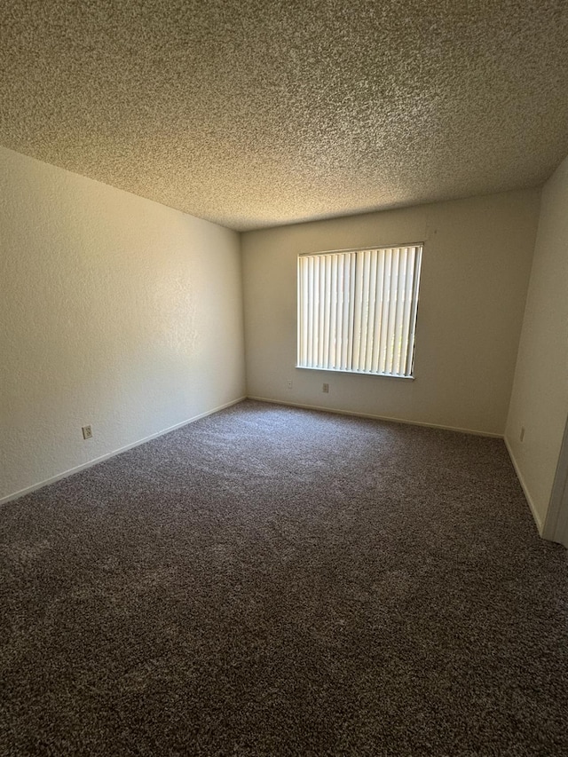 4303 N Emerson Ave, Fresno, CA 93705 - carpeted empty room with a textured ceiling and baseboards