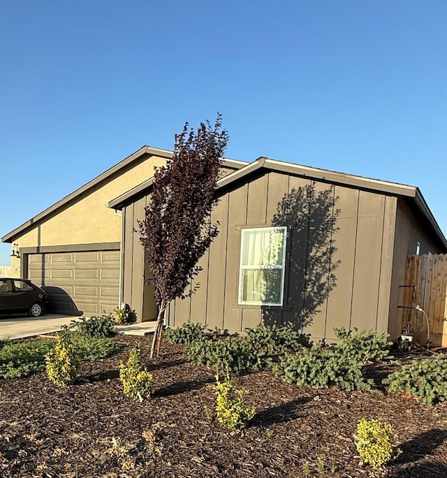1607 Seneca Dr, Madera, CA 93637 - view of home's exterior with a garage and board and batten siding