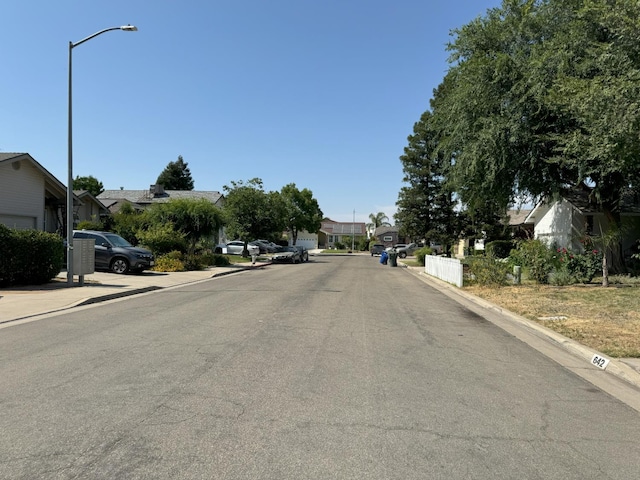 650 N Burgan Ave, Fresno, CA 93727 - view of asphalt street featuring street lights, curbs, a residential view, and sidewalks