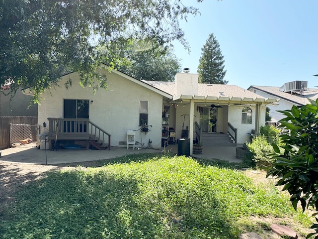 650 N Burgan Ave, Fresno, CA 93727 - back of property with a patio, stucco siding, a chimney, and a ceiling fan