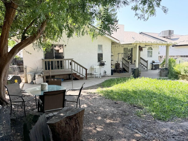 650 N Burgan Ave, Fresno, CA 93727 - rear view of house featuring a patio area, stucco siding, and a chimney