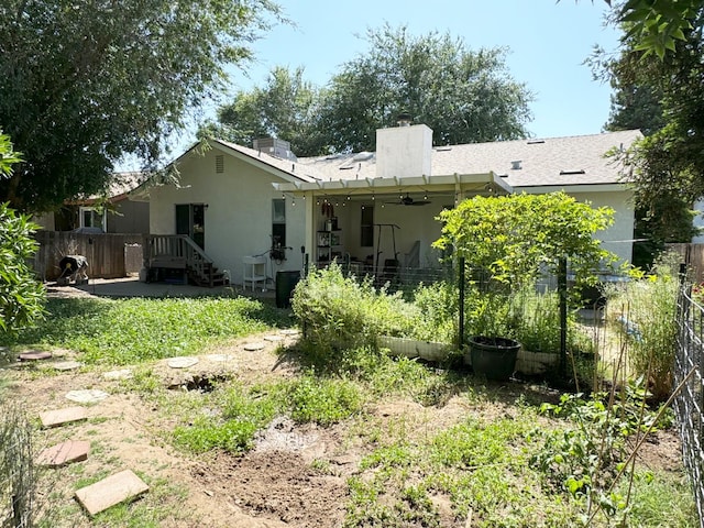 650 N Burgan Ave, Fresno, CA 93727 - back of house featuring stucco siding, a chimney, ceiling fan, and a patio