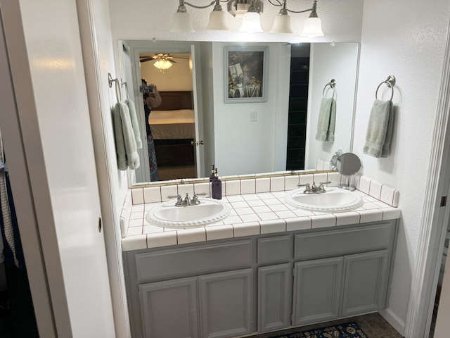 650 N Burgan Ave, Fresno, CA 93727 - ensuite bathroom featuring double vanity and ceiling fan