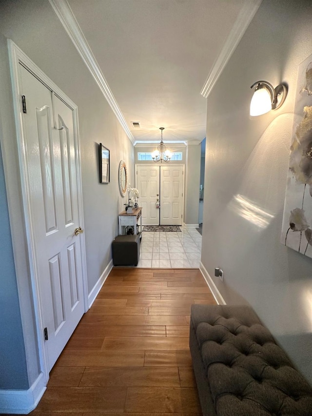 7310 N Katy Ave, Fresno, CA 93722 - foyer entrance with wood-type flooring, ornamental molding, and a chandelier