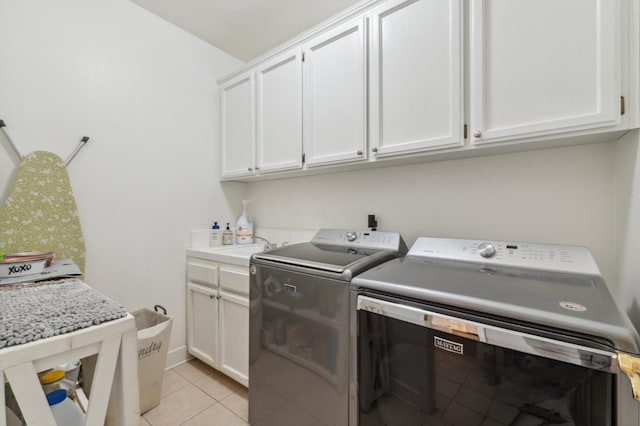 7310 N Katy Ave, Fresno, CA 93722 - washroom featuring washing machine and clothes dryer, cabinet space, and light tile patterned floors