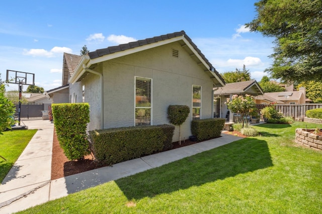 7310 N Katy Ave, Fresno, CA 93722 - view of property exterior with stucco siding and a tiled roof