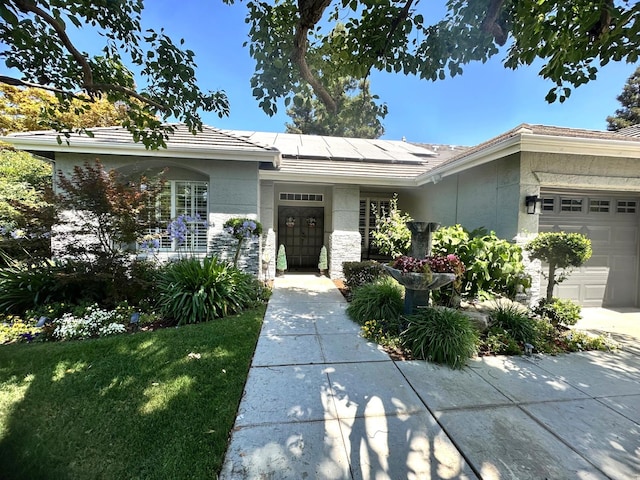7310 N Katy Ave, Fresno, CA 93722 - ranch-style house featuring solar panels, a garage, and stucco siding