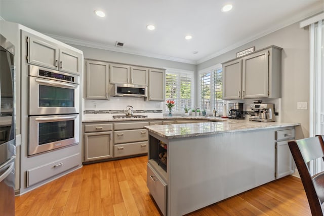 7310 N Katy Ave, Fresno, CA 93722 - kitchen with appliances with stainless steel finishes, gray cabinetry, a peninsula, crown molding, and recessed lighting