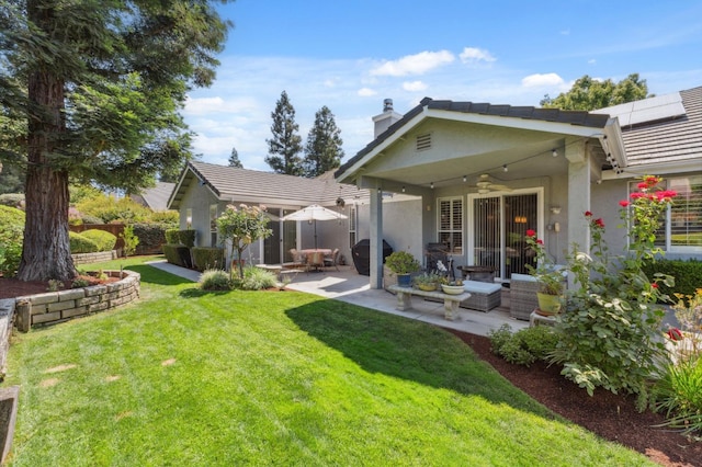 7310 N Katy Ave, Fresno, CA 93722 - back of house featuring stucco siding, a patio, a tiled roof, a chimney, and a ceiling fan