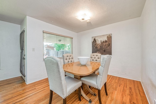 3625 E Cortland Ave, Fresno, CA 93726 - dining room featuring light wood-type flooring and a textured ceiling