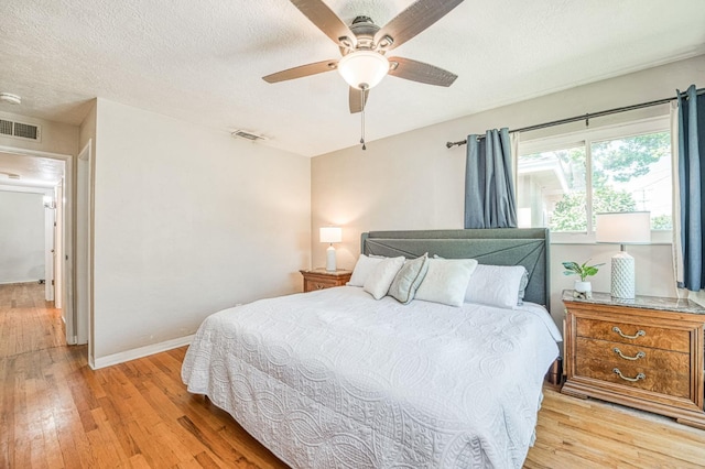 3625 E Cortland Ave, Fresno, CA 93726 - bedroom with light wood-style flooring, a textured ceiling, and ceiling fan