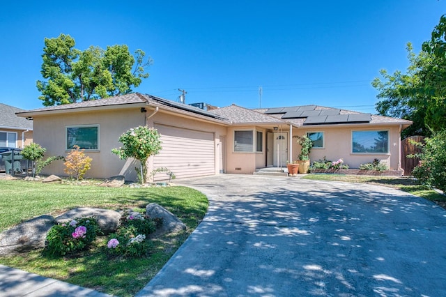 3625 E Cortland Ave, Fresno, CA 93726 - single story home with stucco siding, an attached garage, driveway, and solar panels