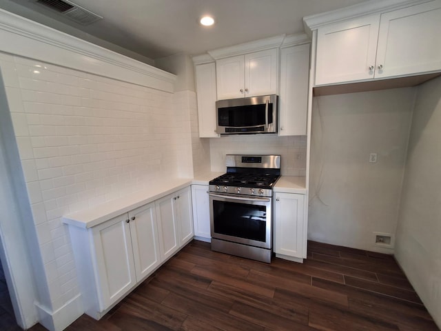 535 E Princeton Ave, Fresno, CA 93704 - kitchen with appliances with stainless steel finishes, dark wood finished floors, light countertops, white cabinets, and tasteful backsplash