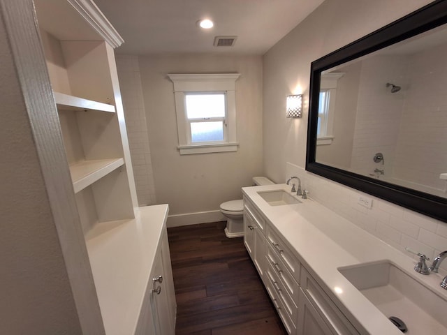 535 E Princeton Ave, Fresno, CA 93704 - bathroom with double vanity, decorative backsplash, wood finished floors, and recessed lighting
