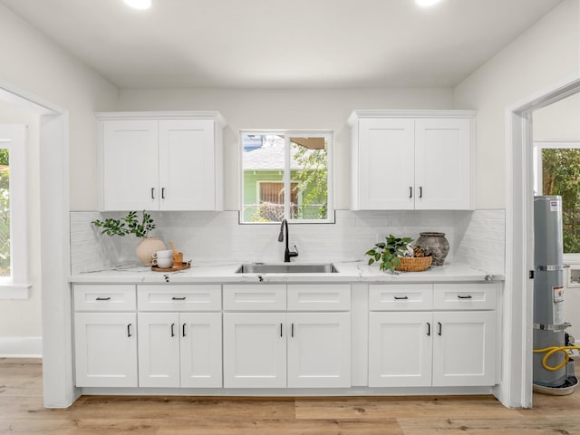 3644 E Illinois Ave, Fresno, CA 93702 - kitchen with white cabinetry, light countertops, and tasteful backsplash