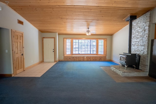 38475 Sierra Lakes Dr, Oakhurst, CA 93644 - unfurnished living room with a wood stove, vaulted ceiling, wooden ceiling, carpet, and ceiling fan