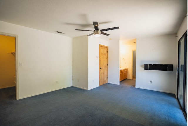 38475 Sierra Lakes Dr, Oakhurst, CA 93644 - unfurnished bedroom with dark colored carpet, a ceiling fan, and ensuite bathroom