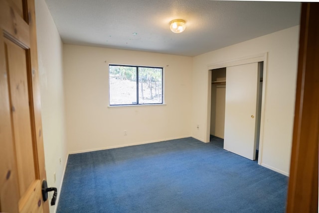 38475 Sierra Lakes Dr, Oakhurst, CA 93644 - unfurnished bedroom with dark colored carpet and a closet