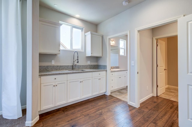 1072 Soledad Ave, Clovis, CA 93619 - kitchen with white cabinetry, dark wood finished floors, plenty of natural light, light stone countertops, and recessed lighting