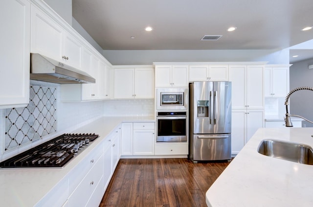1072 Soledad Ave, Clovis, CA 93619 - kitchen with appliances with stainless steel finishes, under cabinet range hood, white cabinetry, and recessed lighting