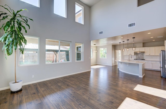 1072 Soledad Ave, Clovis, CA 93619 - unfurnished living room featuring dark wood-type flooring and a towering ceiling