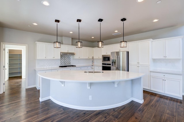1072 Soledad Ave, Clovis, CA 93619 - kitchen featuring appliances with stainless steel finishes, tasteful backsplash, light countertops, white cabinetry, and recessed lighting
