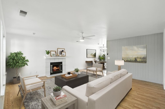 13570 7th, Parlier, CA 93648 - living room with light wood-style floors, ceiling fan, and a tile fireplace