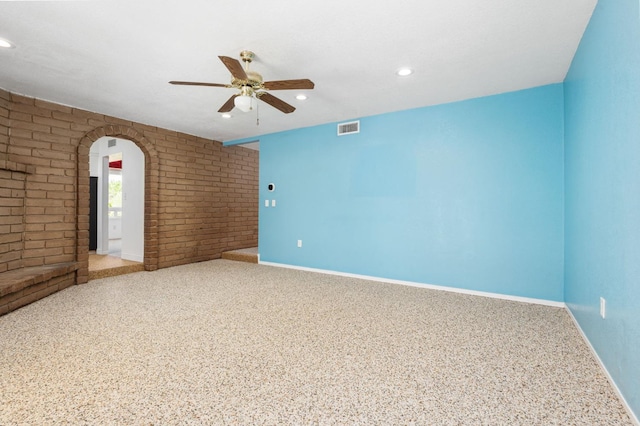 4760 N Rowell Ave, Fresno, CA 93726 - spare room with ceiling fan, brick wall, arched walkways, and recessed lighting